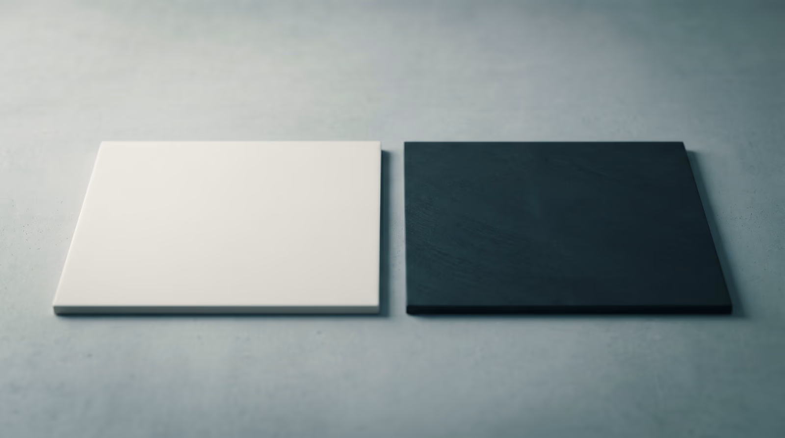 Two square swatch tiles side by side — one light and one very dark — demonstrating stark color contrast for accessible color and typography design