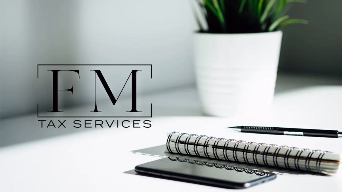 FM Tax Services logo displayed on a desk mockup, designed by Desque
