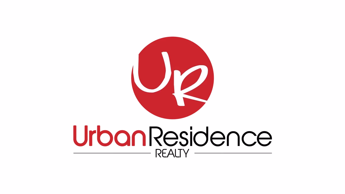 Urban Residence Realty brand identity designed by Desque, circular monogram badge on dark background