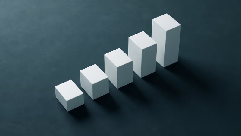 Ascending matte rectangular blocks arranged in a staircase pattern on a dark slate surface, representing content marketing growth and return on investment