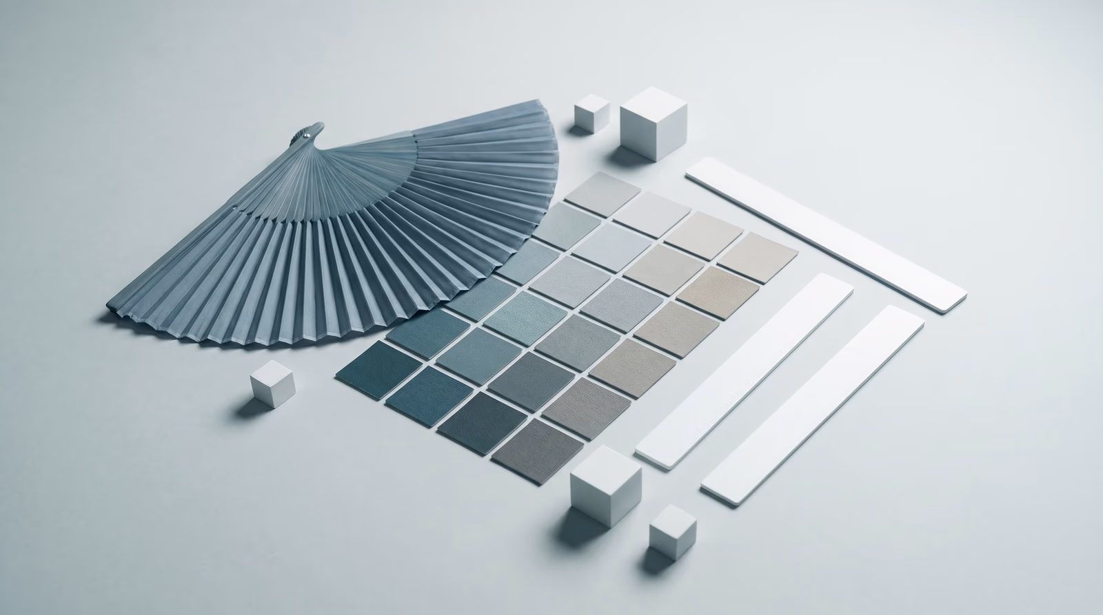 Unlabeled color swatch chips in a teal-to-neutral gradient arranged alongside blank spacing ruler sticks, representing design tokens and visual design variables
