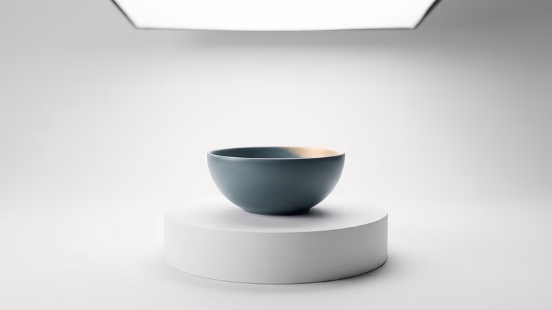 A single unbranded minimalist ceramic object on a white studio pedestal with soft directional lighting, representing ecommerce product page optimization and conversion design