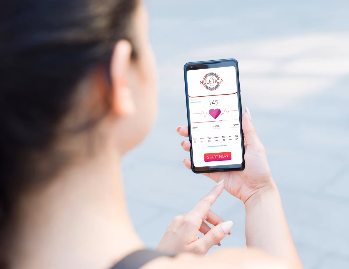 Nuletica Fitness mobile app interface mockup showing brand identity applied digitally, designed by Desque