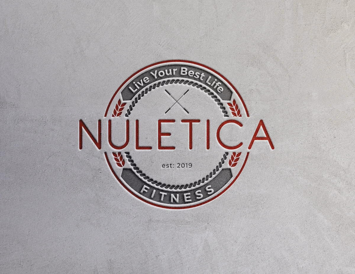 Nuletica Fitness logo embossed on concrete wall, brand identity by Desque
