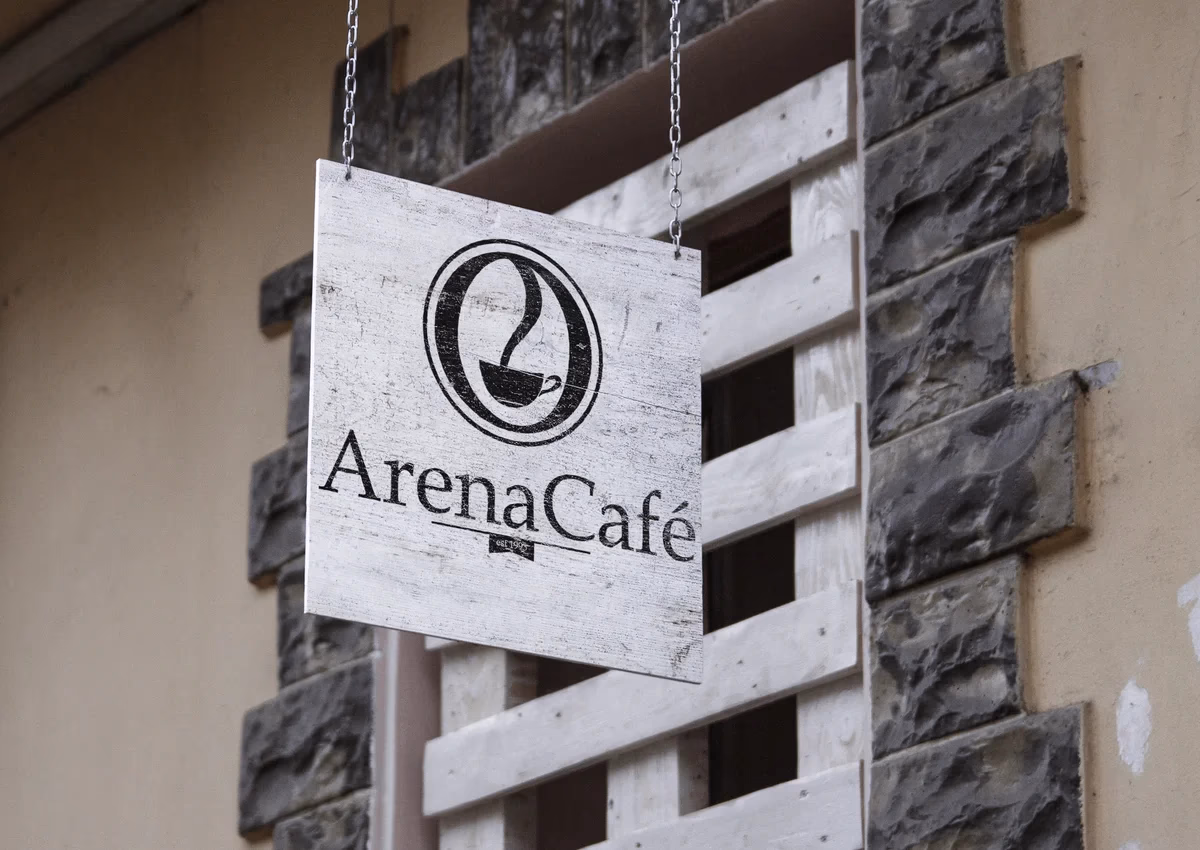 Arena Cafe hanging wooden sign mockup showing the brand identity designed by Desque