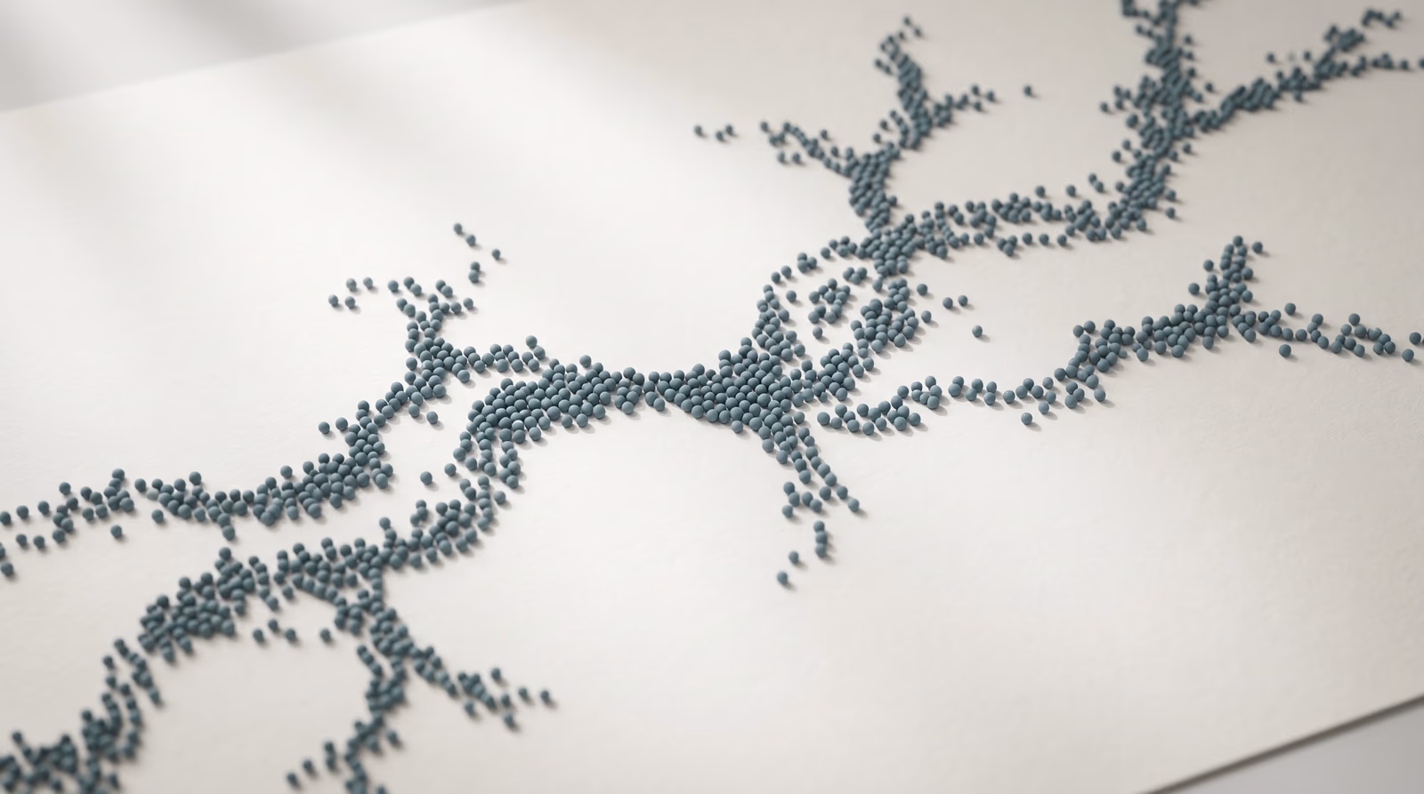 Overhead view of abstract dotted spheres forming a branching path across a pale surface, representing user behavior flow and navigation patterns on a website