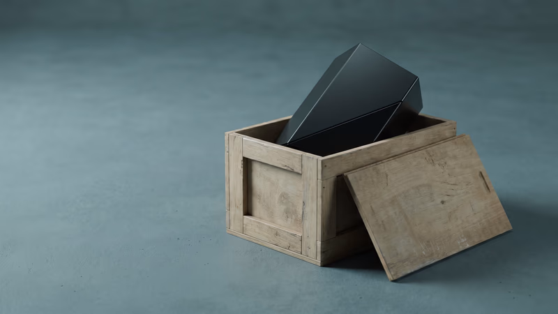 A polished geometric object breaking free from a plain wooden crate on a minimalist surface — visual metaphor for a website outgrowing its platform constraints